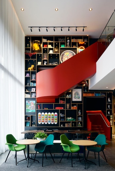 washington dc capitol citizenM blue green chairs wall bookshelf red spiral staircase
